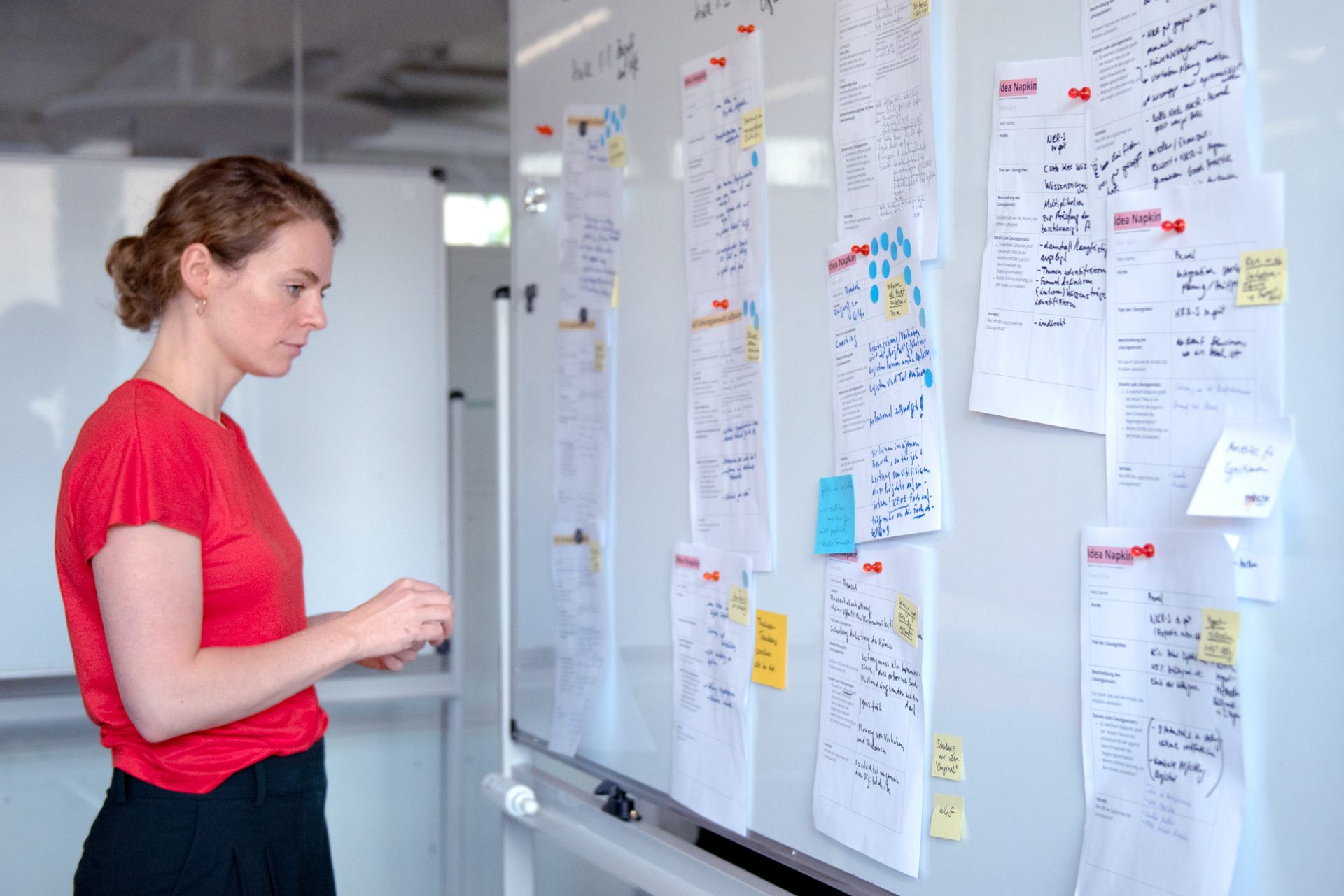 A DigitalService employee looks at notes on a whiteboard