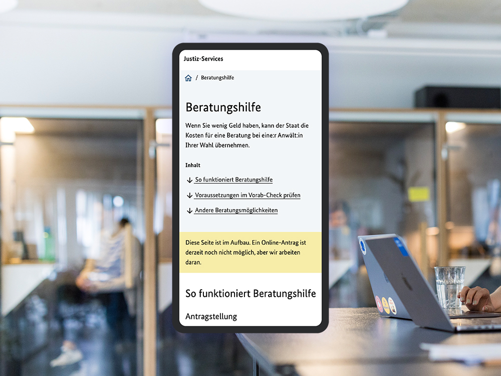 A smartphone screen shows the homepage of the “Assistance with Legal Counsel” justice service; the DigitalService office can be seen in the background as a visual style element